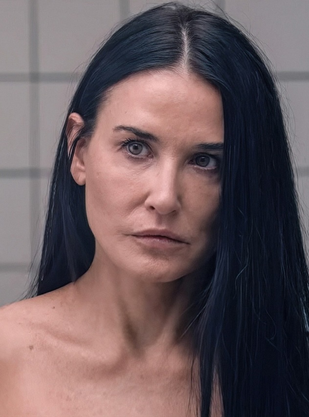 Demi Moore’s character in The Substance looking into a mirror, reflecting identity split, projection, and psychological aggression.